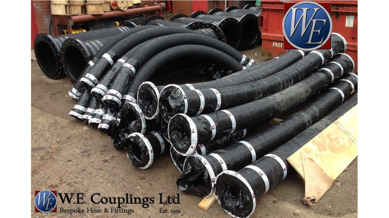 8 inch rubber hoses stacked outside factory